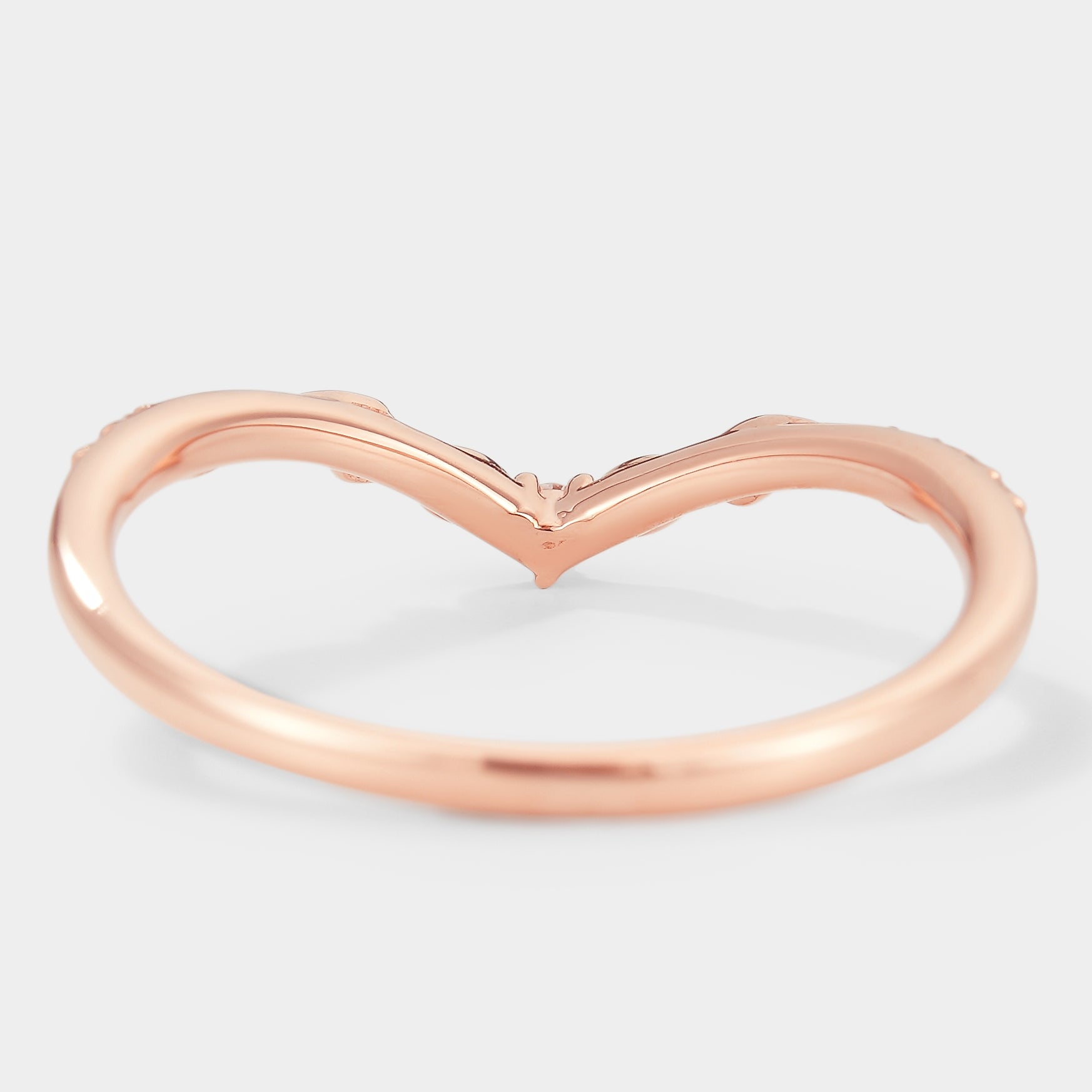Rose gold V-shaped wedding band with leaf details