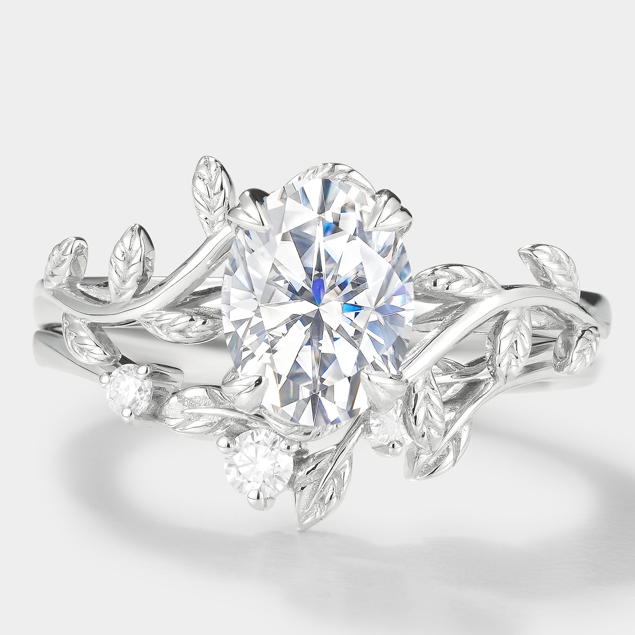 Oval moissanite engagement ring set with leaf design
