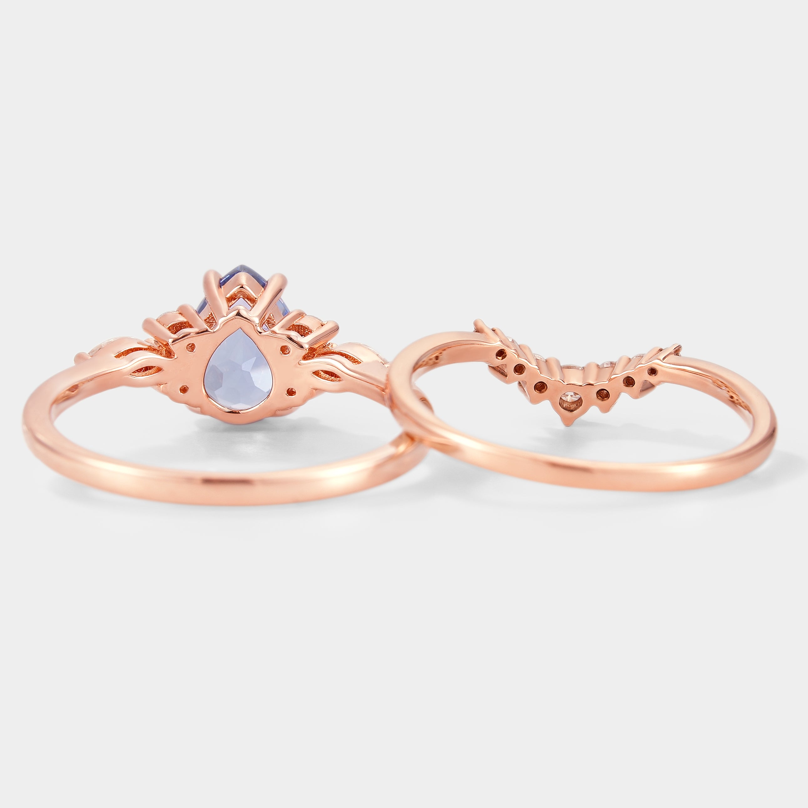 Rose gold pear cut cornflower sapphire engagement ring with curved moissanite wedding band, bridal set