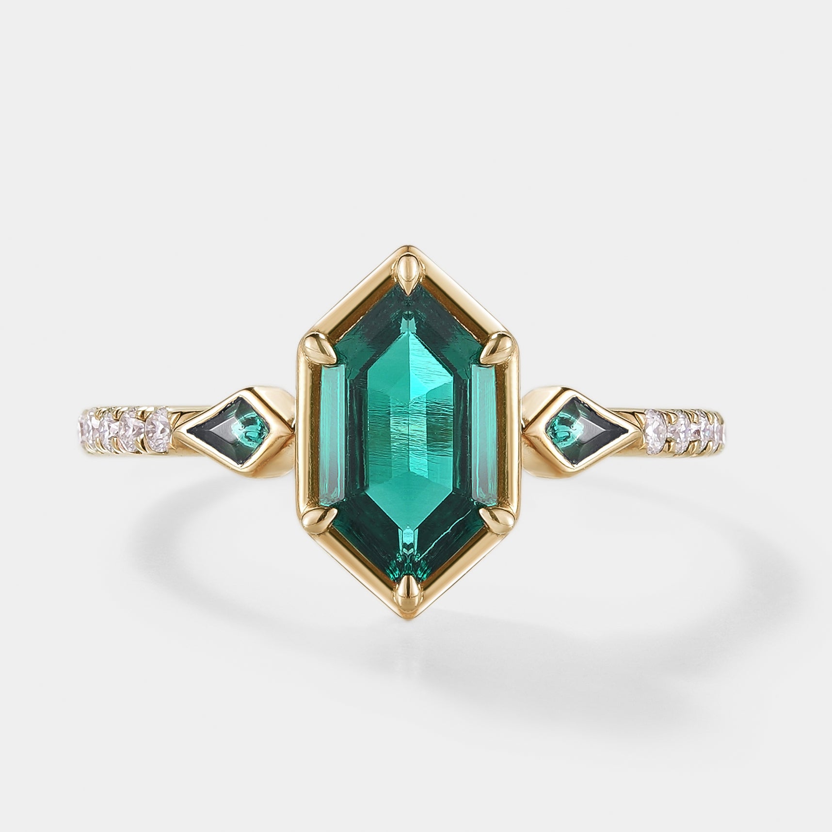 Hexagon cut emerald engagement ring with kite cut accent stones
