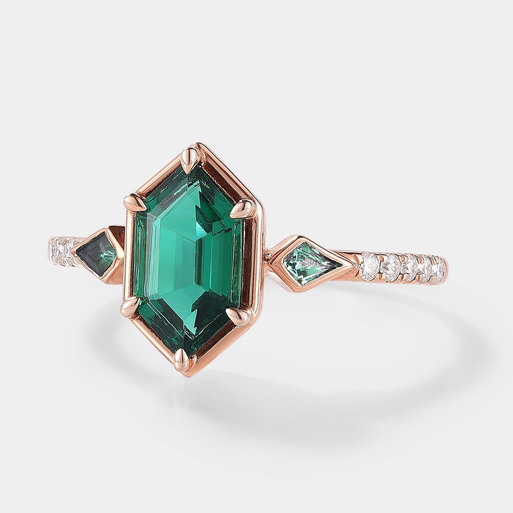 Rose gold emerald engagement ring with unique hexagon cut