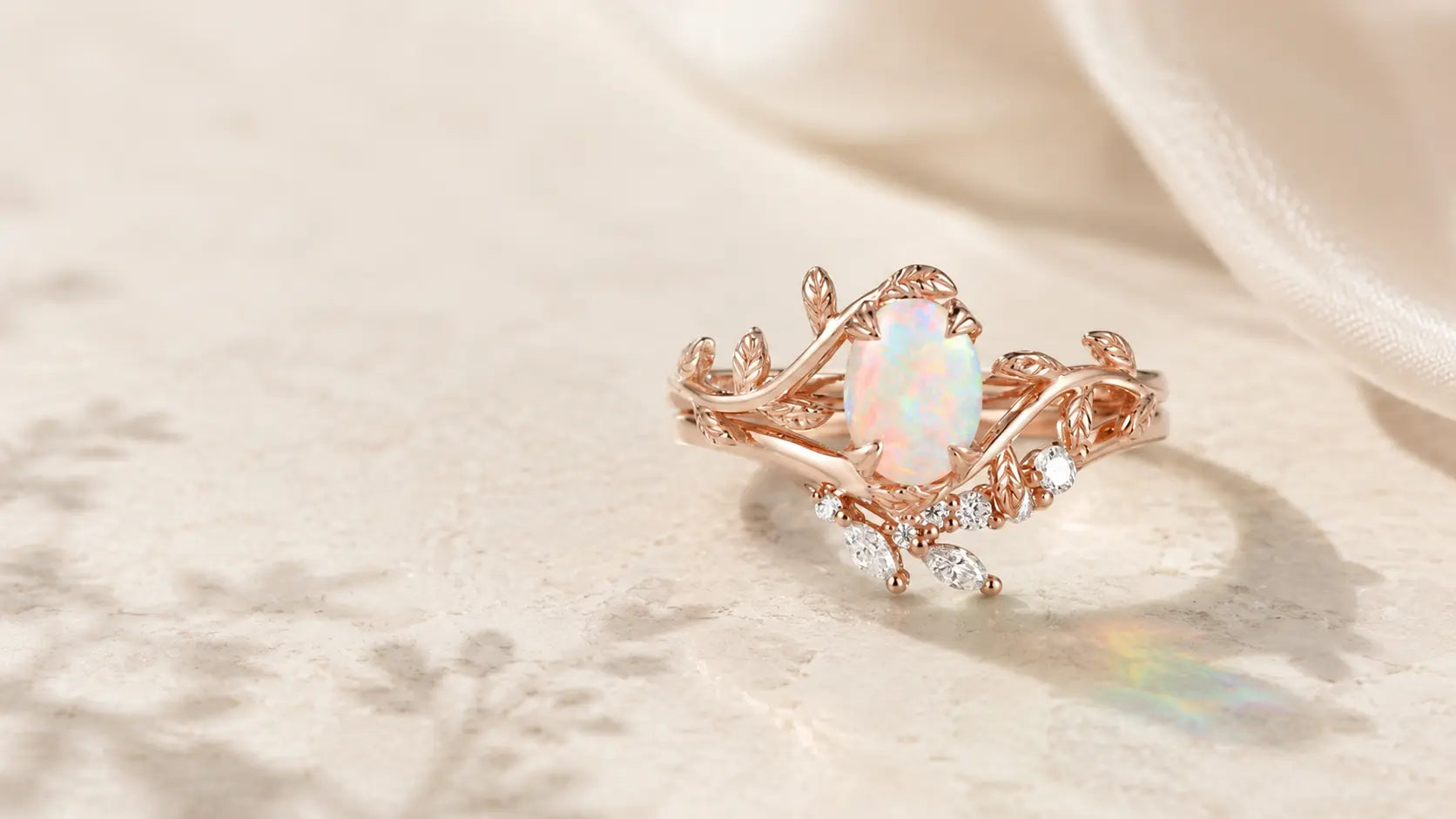 Nature-inspired opal engagement ring with rose gold leaf and vine details