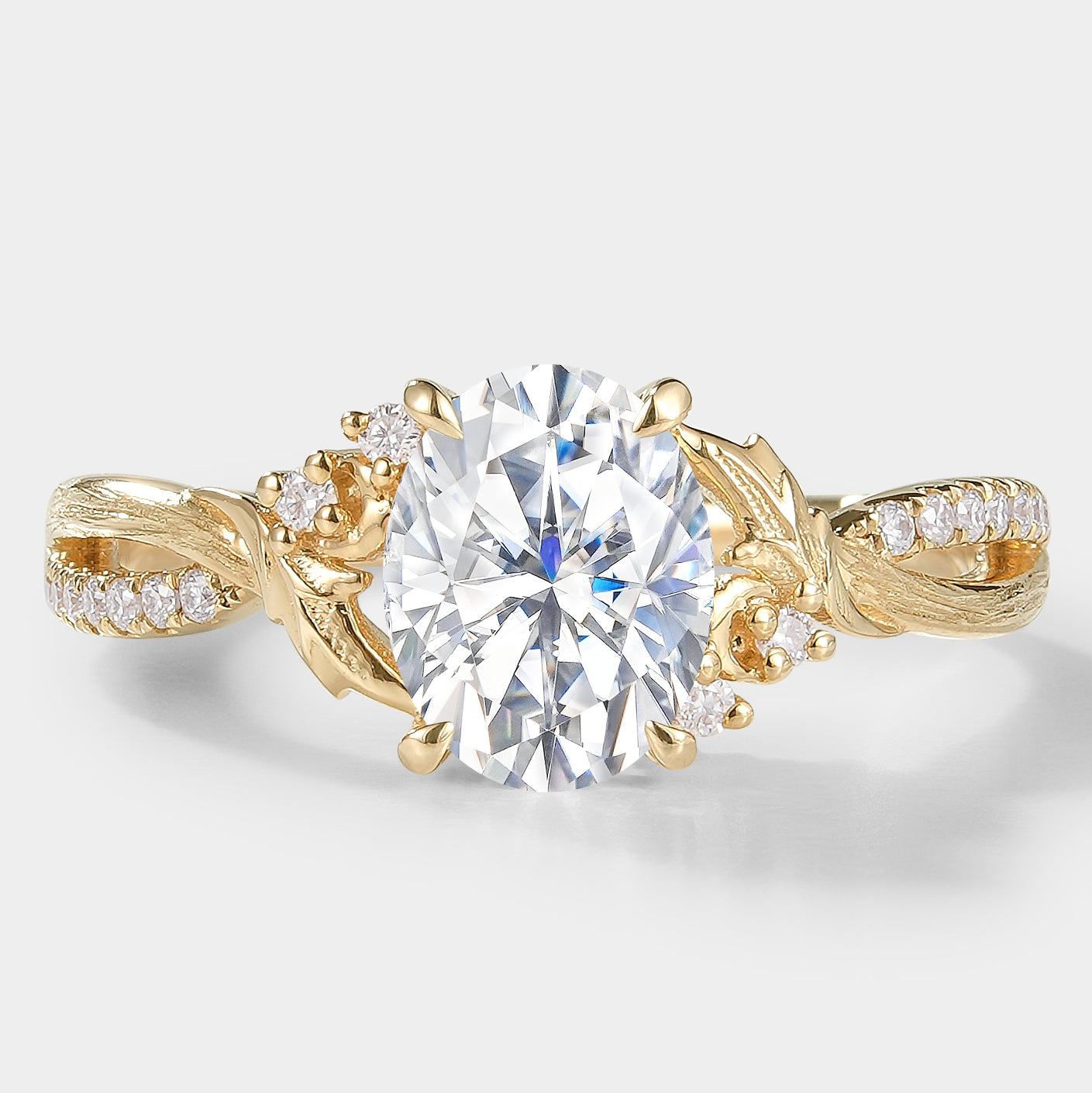Oval moissanite engagement ring, leaf and bark band in yellow gold. Vintage design with diamond accents.