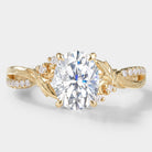 Oval moissanite engagement ring, leaf and bark band in yellow gold. Vintage design with diamond accents.