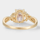Yellow gold oval moissanite engagement ring with leaf and bark design, bridal jewelry