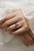 Pear cut alexandrite leaf engagement ring and wedding band set on hand. White gold vintage bridal set.