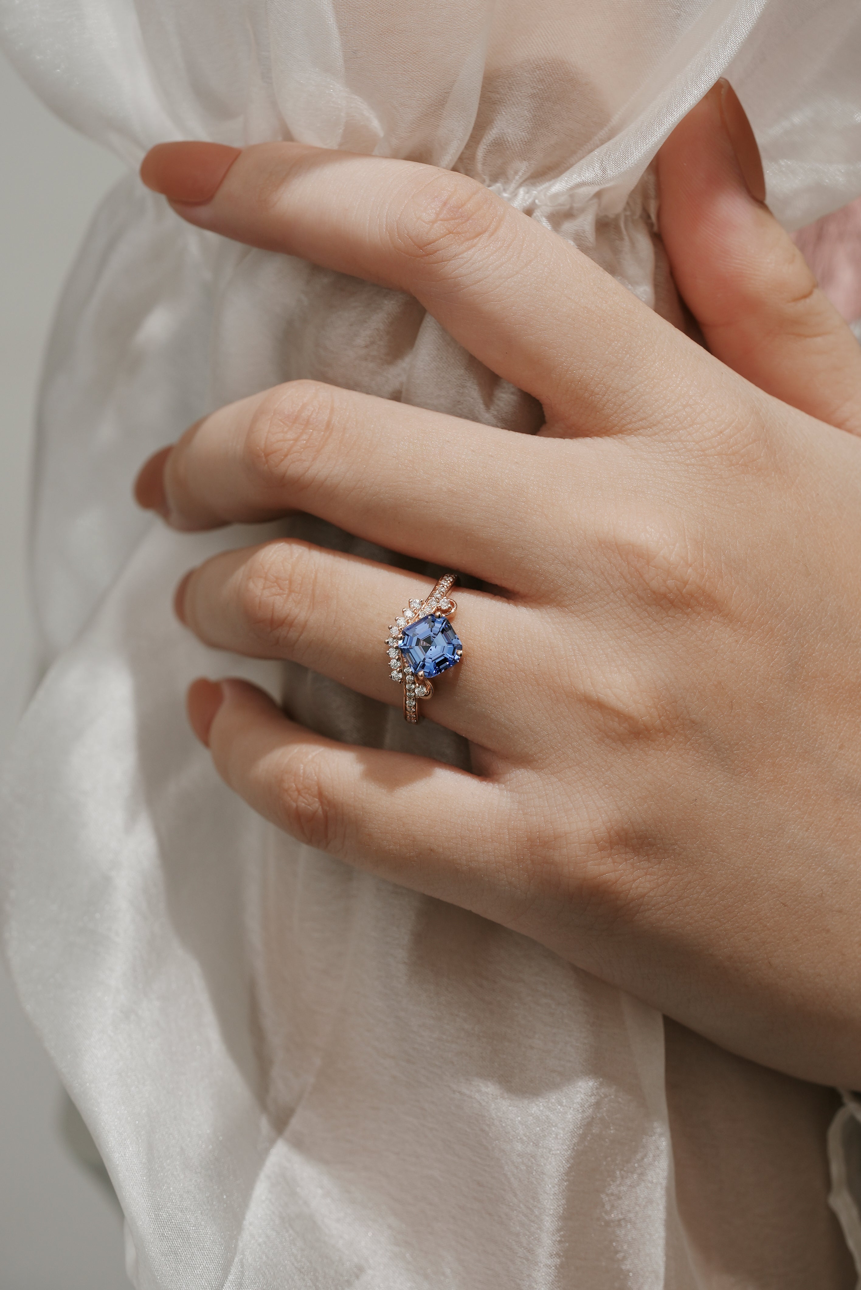 Woman's hand with Cushion Cut Lab Cornflower Sapphire Engagement Ring