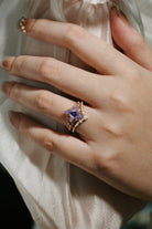 Alexandrite leaf engagement ring set on a hand