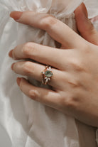 Woman wearing Pear Cut Moss Agate engagement ring set