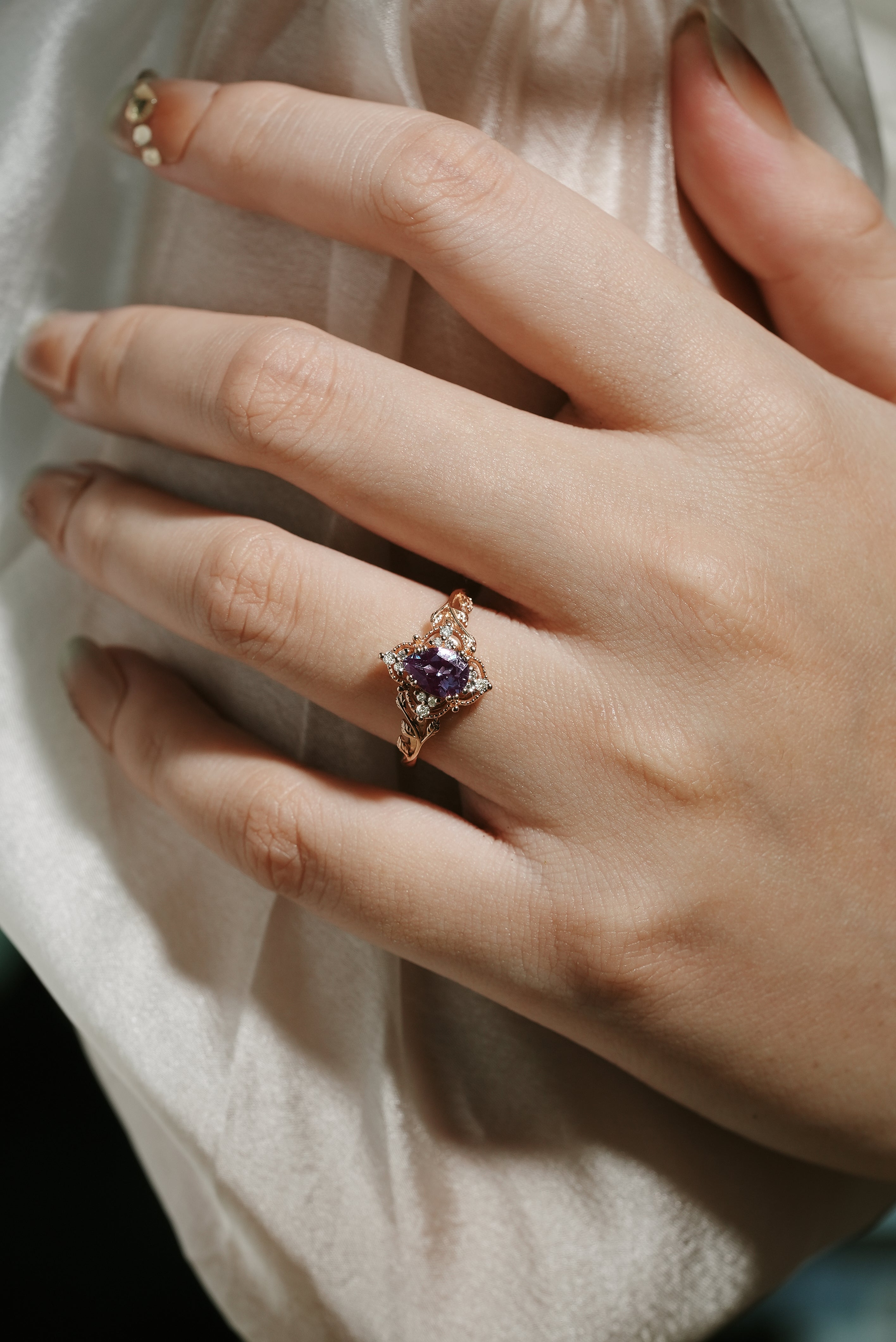 Alexandrite leaf engagement ring on a hand