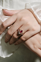 Rose gold lab ruby leaf engagement ring set on hand