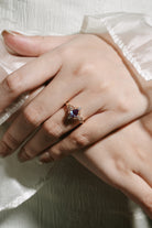 Alexandrite leaf engagement ring on a hand, pear cut