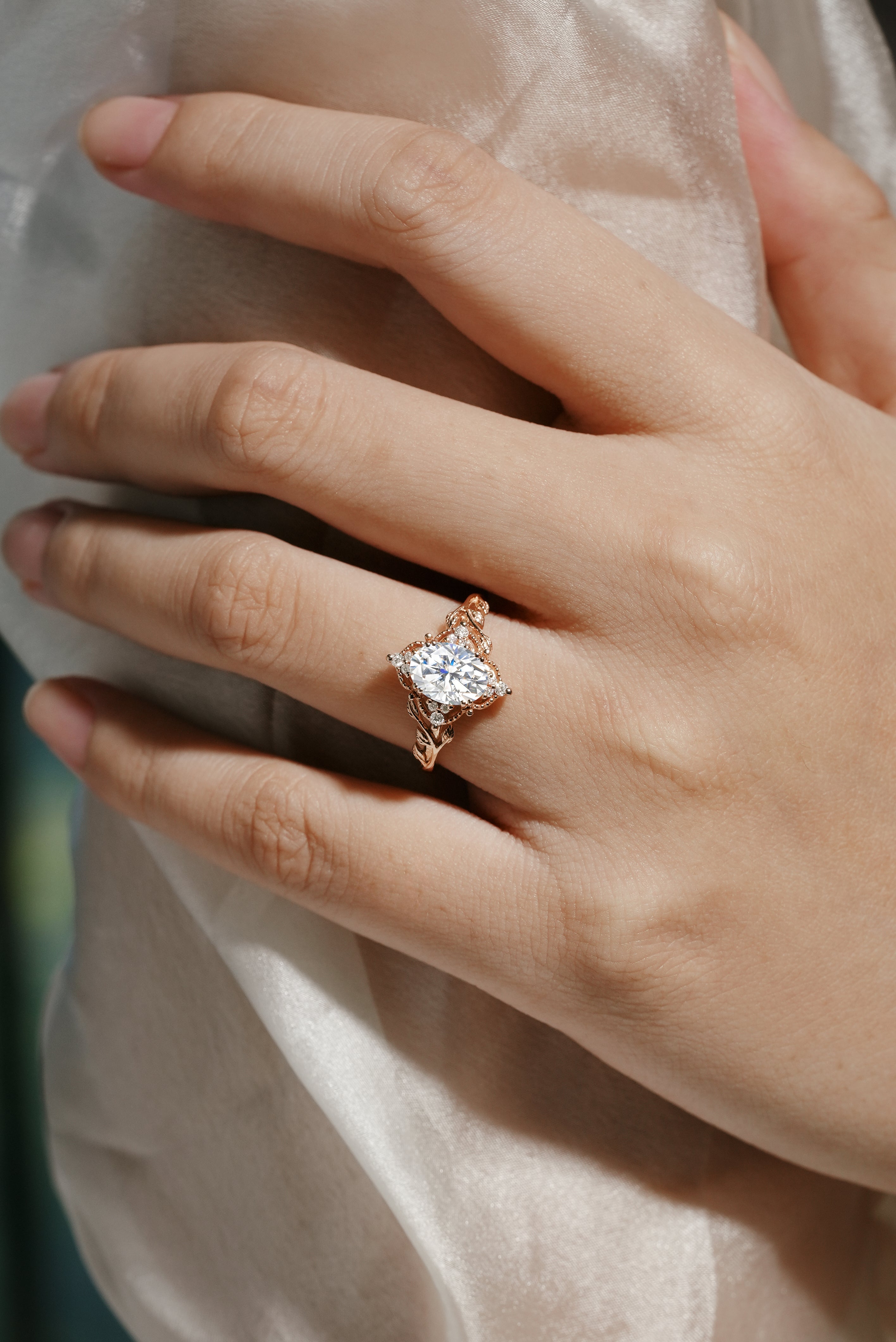 Rose gold leaf engagement ring featuring oval cut moissanite, bridal jewelry