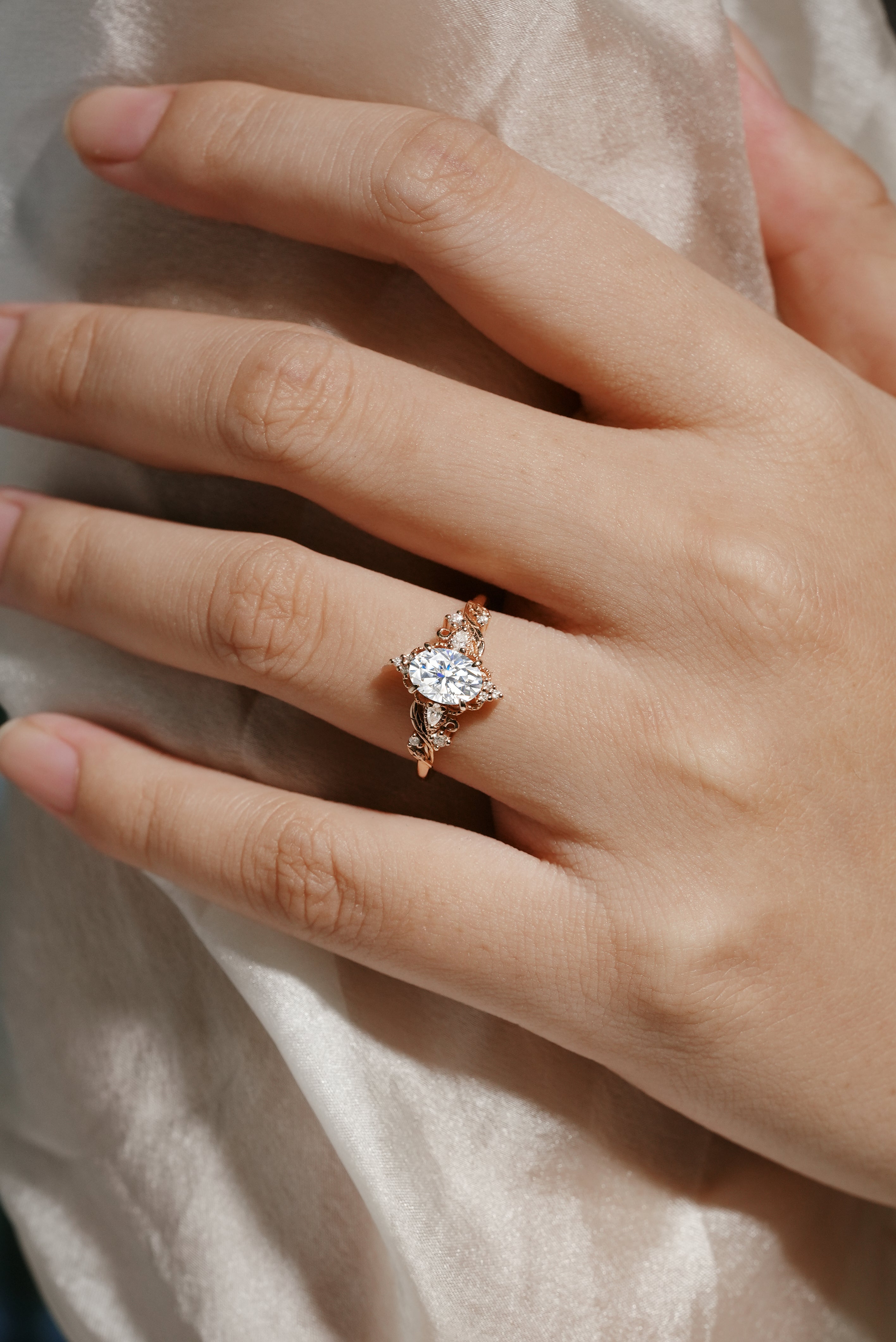 Oval moissanite engagement ring with leaf design in rose gold. Lahela Jewelry Aurelia ring, bridal set.