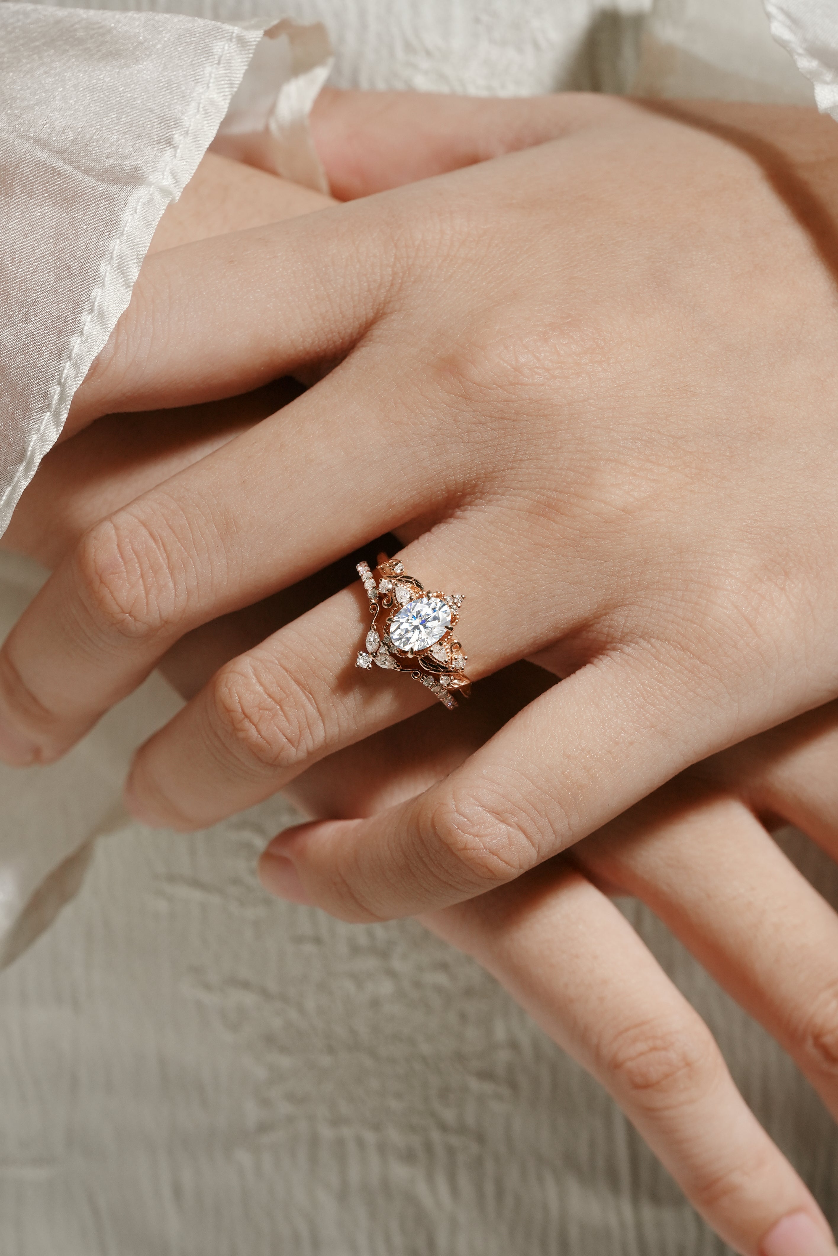 Rose gold moissanite ring set on hand, leaf design, bridal ring set. Oval cut moissanite engagement ring & wedding band.