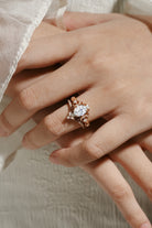 Rose gold vintage moissanite bridal set on hand, oval cut engagement ring and moissanite wedding band