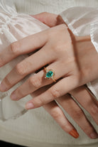 Vintage lab grown emerald engagement ring with moissanite accents, oval cut, yellow gold band, perfect for proposals.