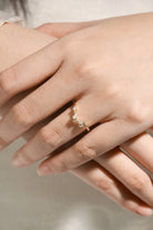 Moissanite leaf band on hand. Nature-inspired wedding ring.