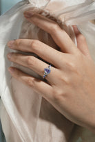 Elegant pear-cut alexandrite engagement ring on hand, moissanite accents, Lahela Jewelry.