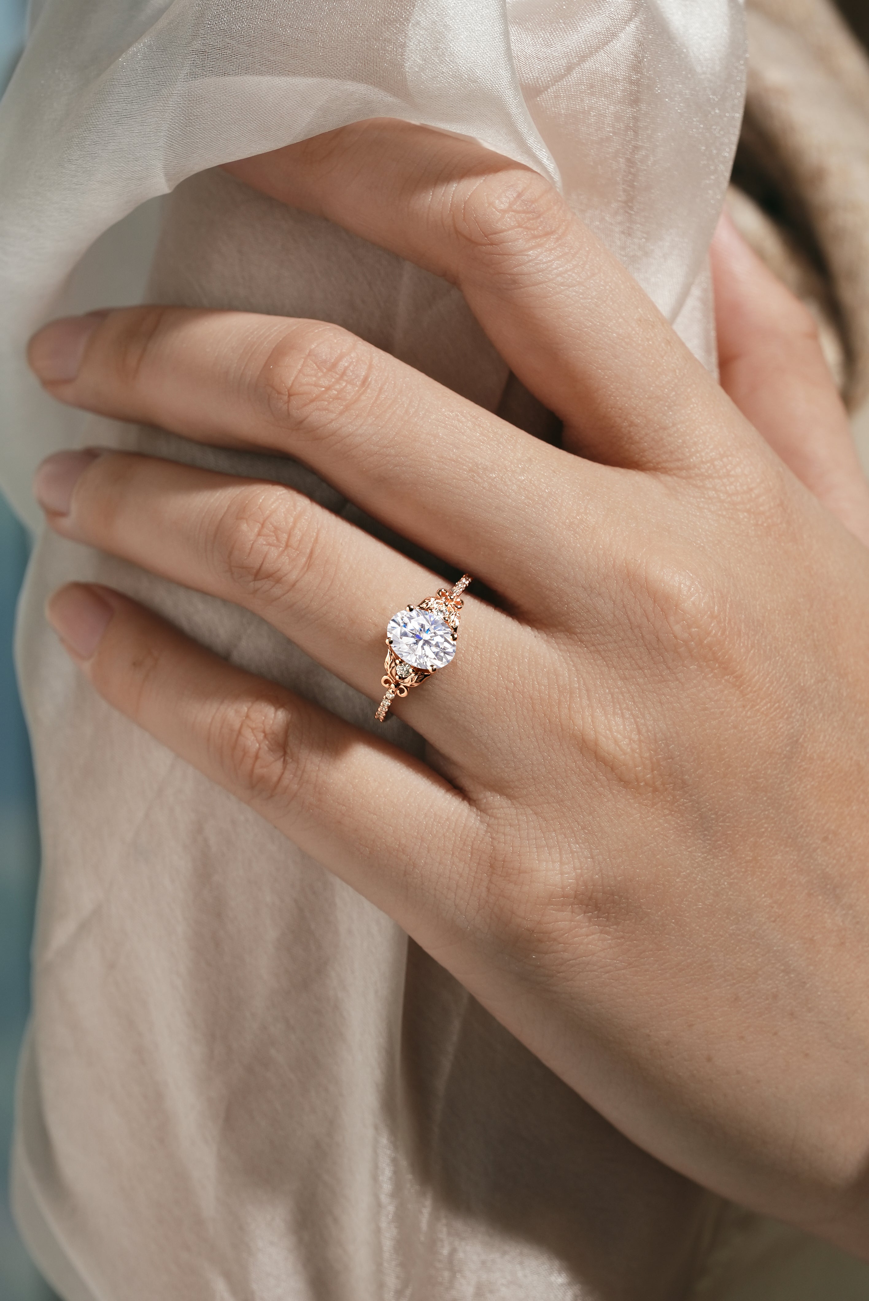 Oval Moissanite Engagement Ring on hand, leaf design