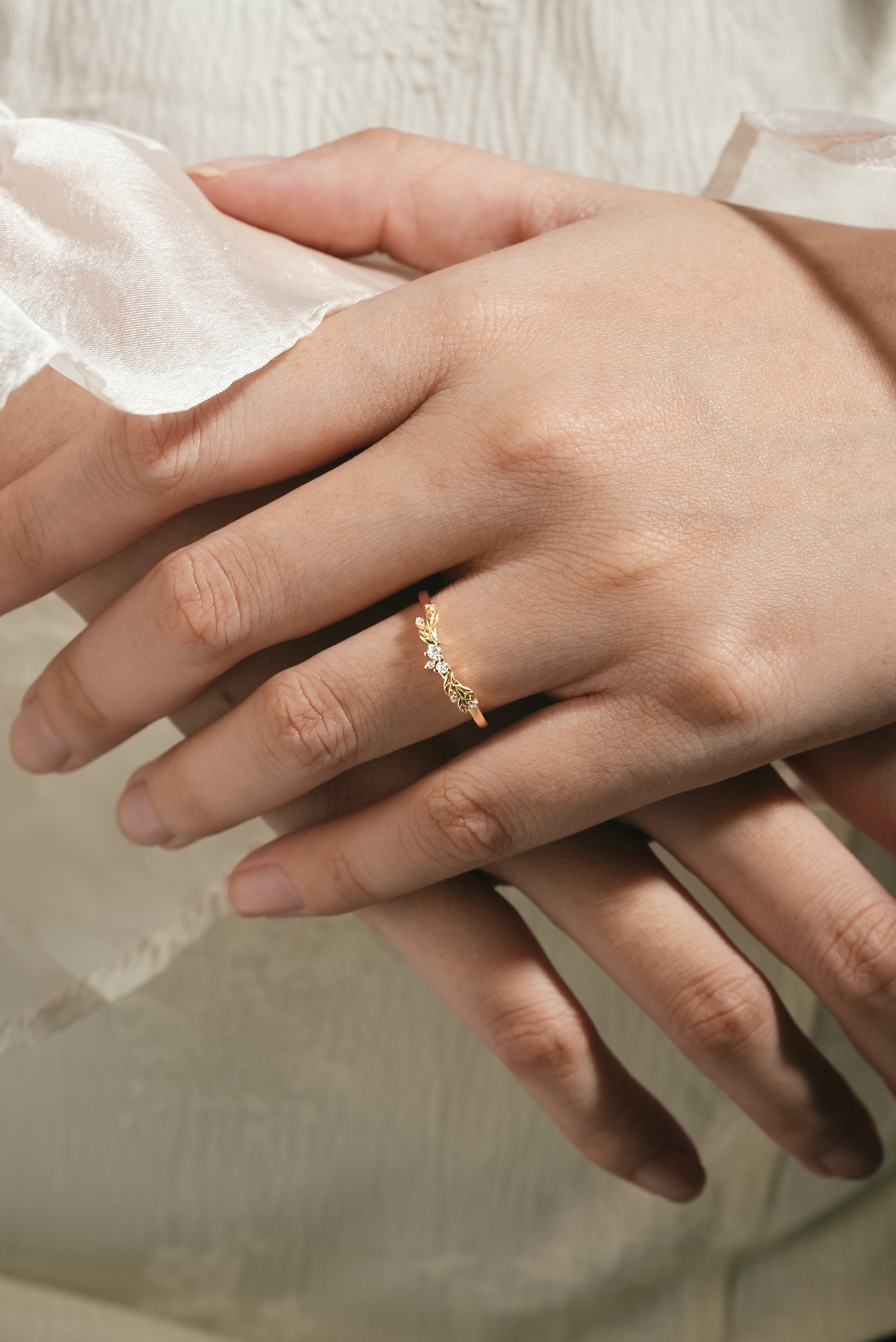 Elegant leaf pattern wedding band on hand, nature-inspired design