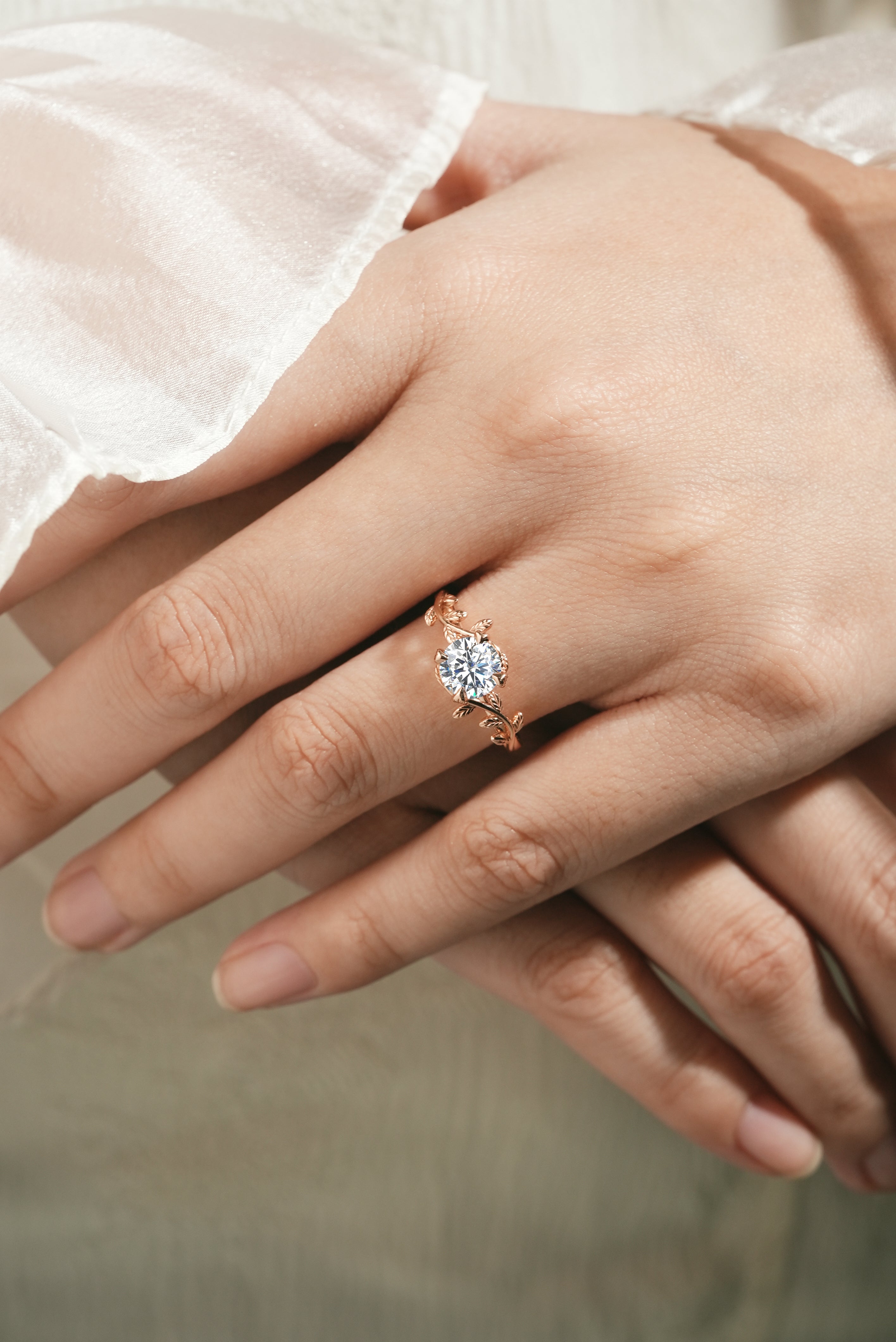 Woman wearing a round moissanite leaf engagement ring