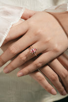 Rose gold Padparadscha sapphire engagement ring on hand