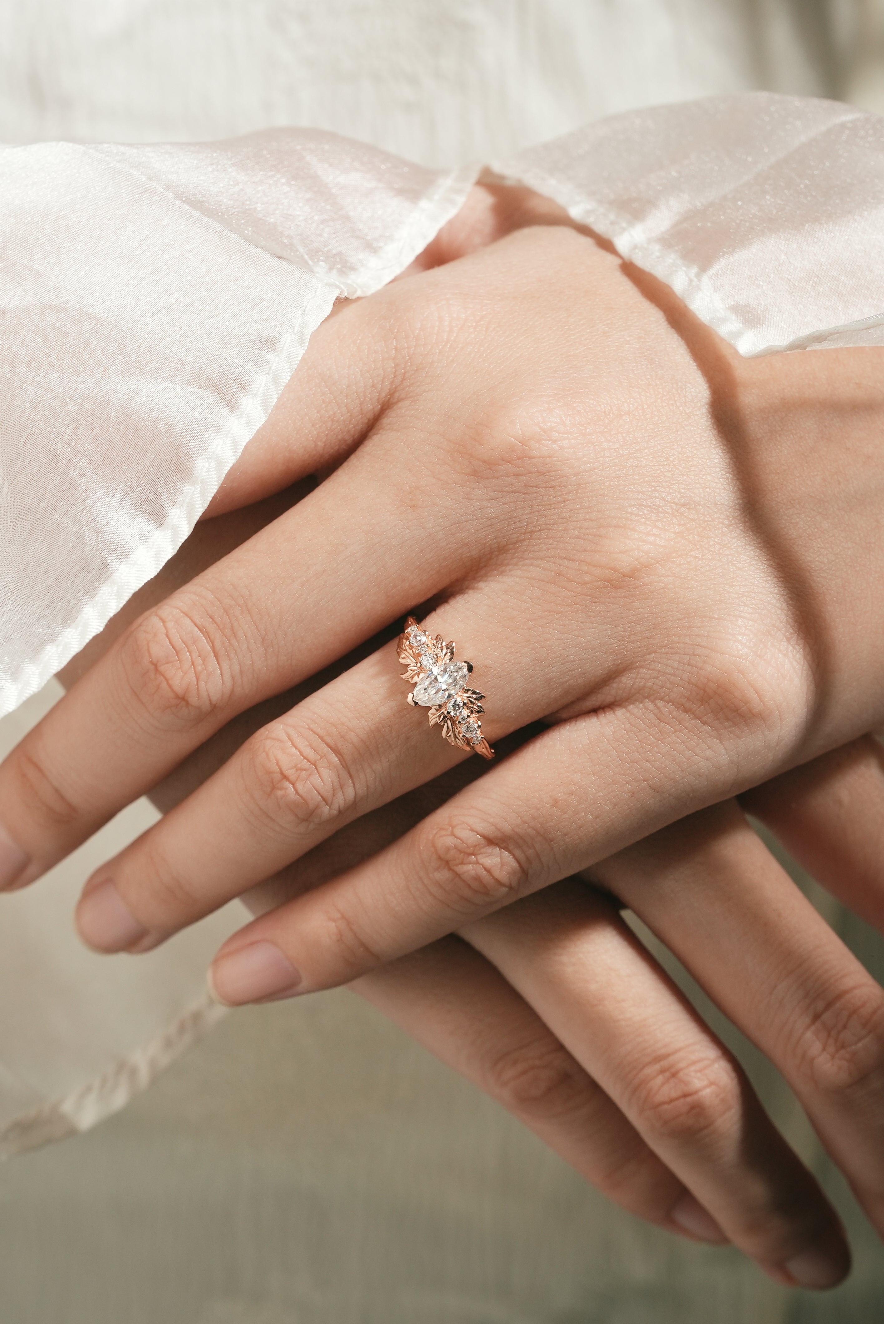 Marquise moissanite leaf engagement ring on hand