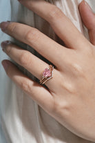 Rose gold heart-cut engagement ring with leaf design and Padparadscha sapphire