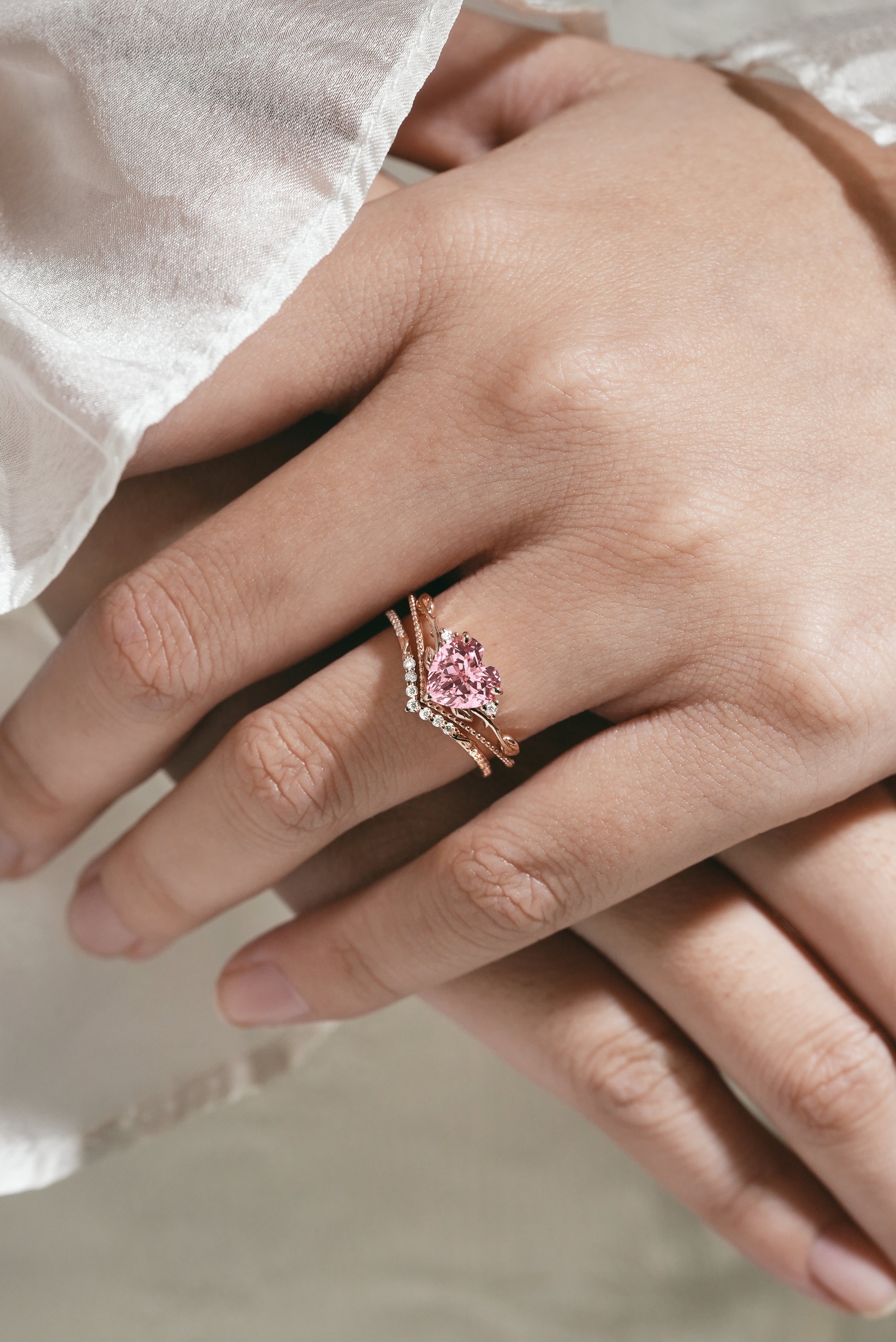 Heart-cut Padparadscha sapphire ring set on hand, leaf design