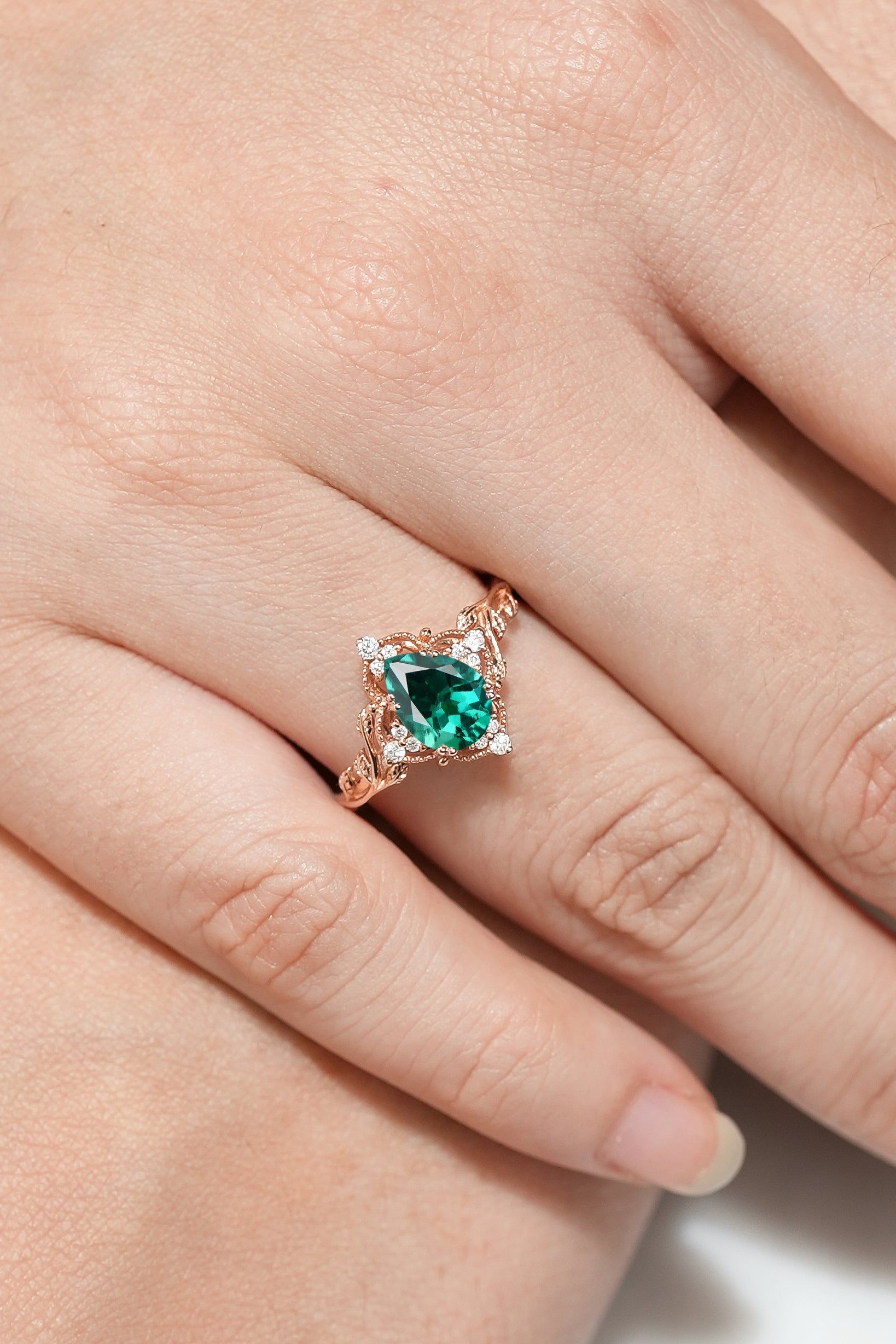 Nature Inspired Leaf Engagement Ring Pear Cut Lab Emerald Ring In Woman's Finger