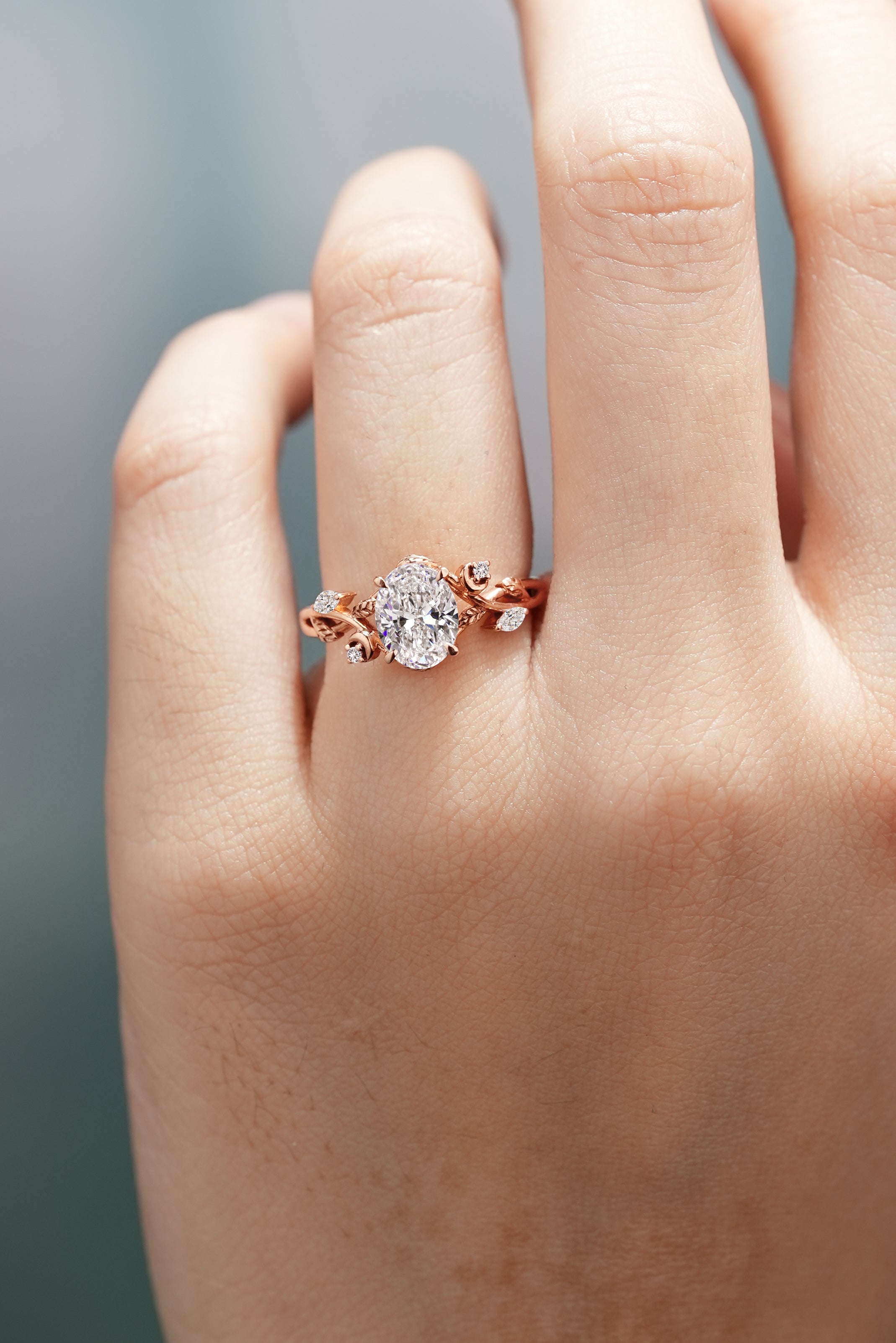 Rose gold leaf engagement ring with oval lab grown diamond