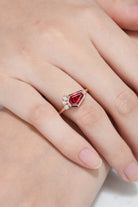 Hand wearing unique coffin cut ruby engagement ring