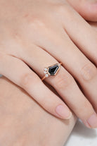 Black onyx coffin cut engagement ring on a finger