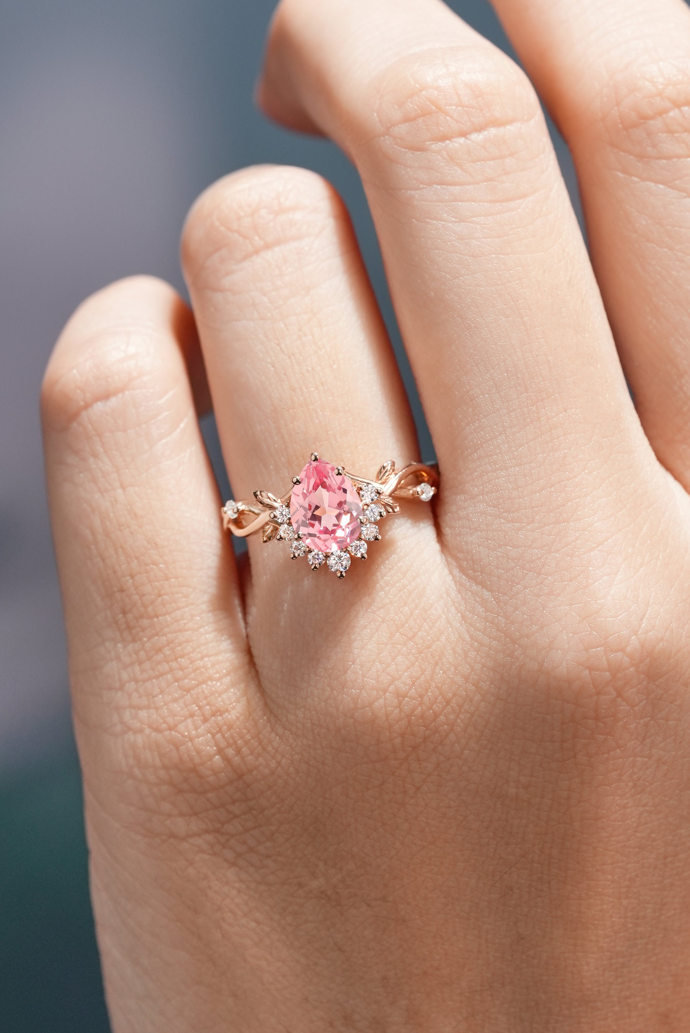 Nature Inspired Leaf Ring Pear Cut Pink Sapphire Engagement Ring Worn On A Finger