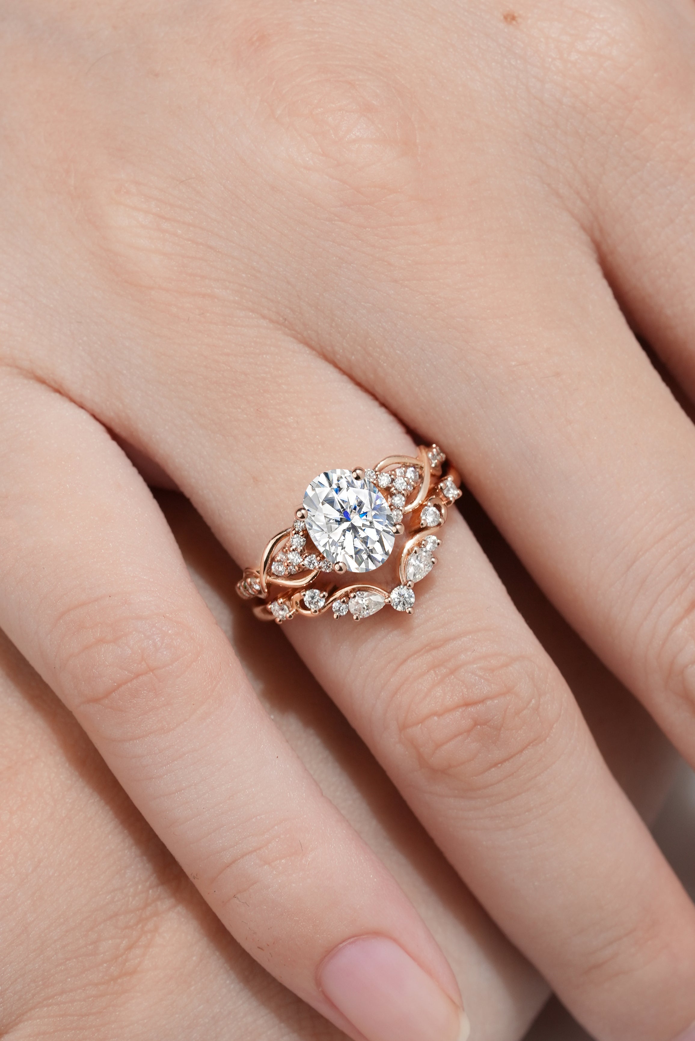Rose gold moissanite engagement ring with nature-inspired leaf detailing