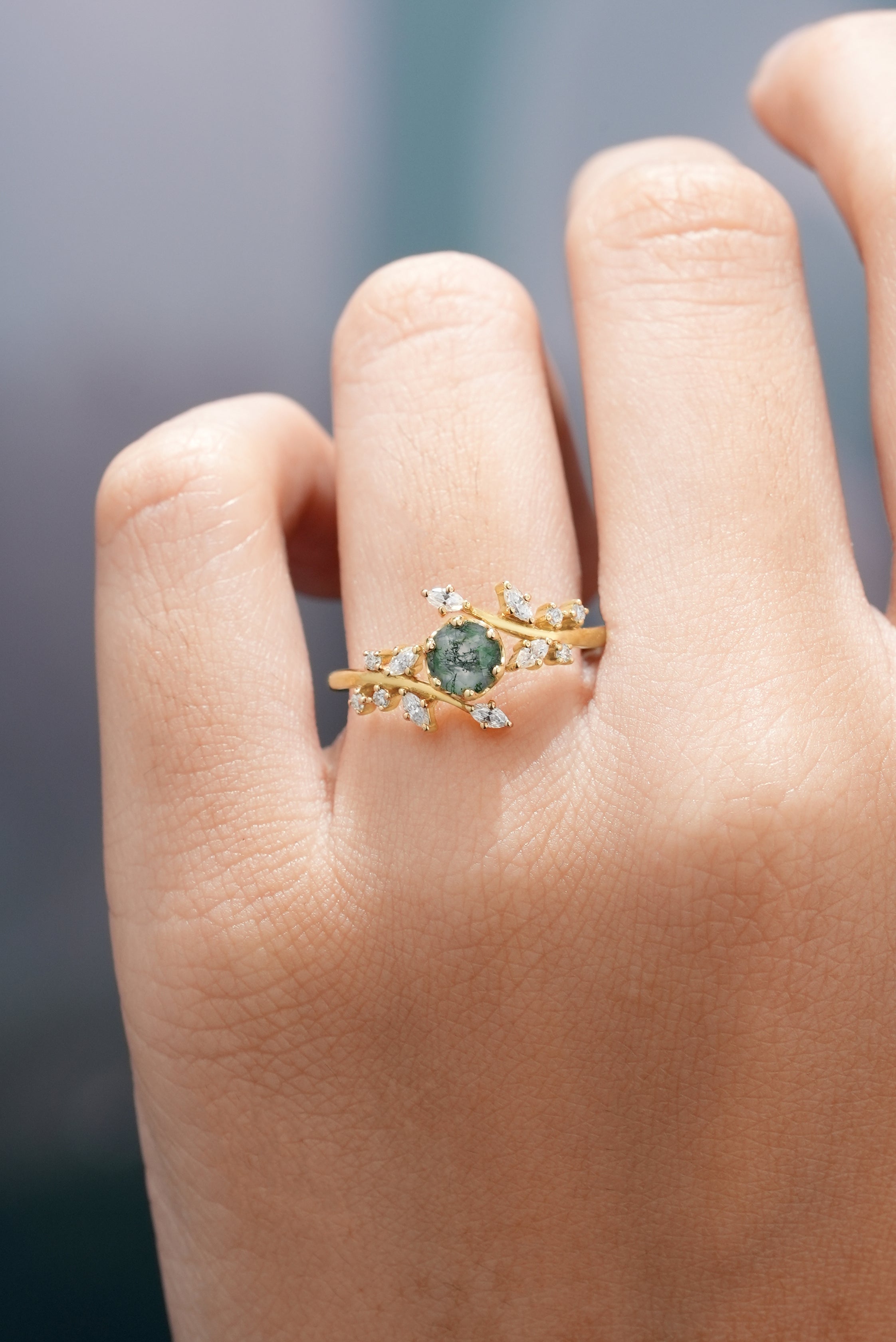 Moss Agate Engagement Ring in Hand with leaf detail