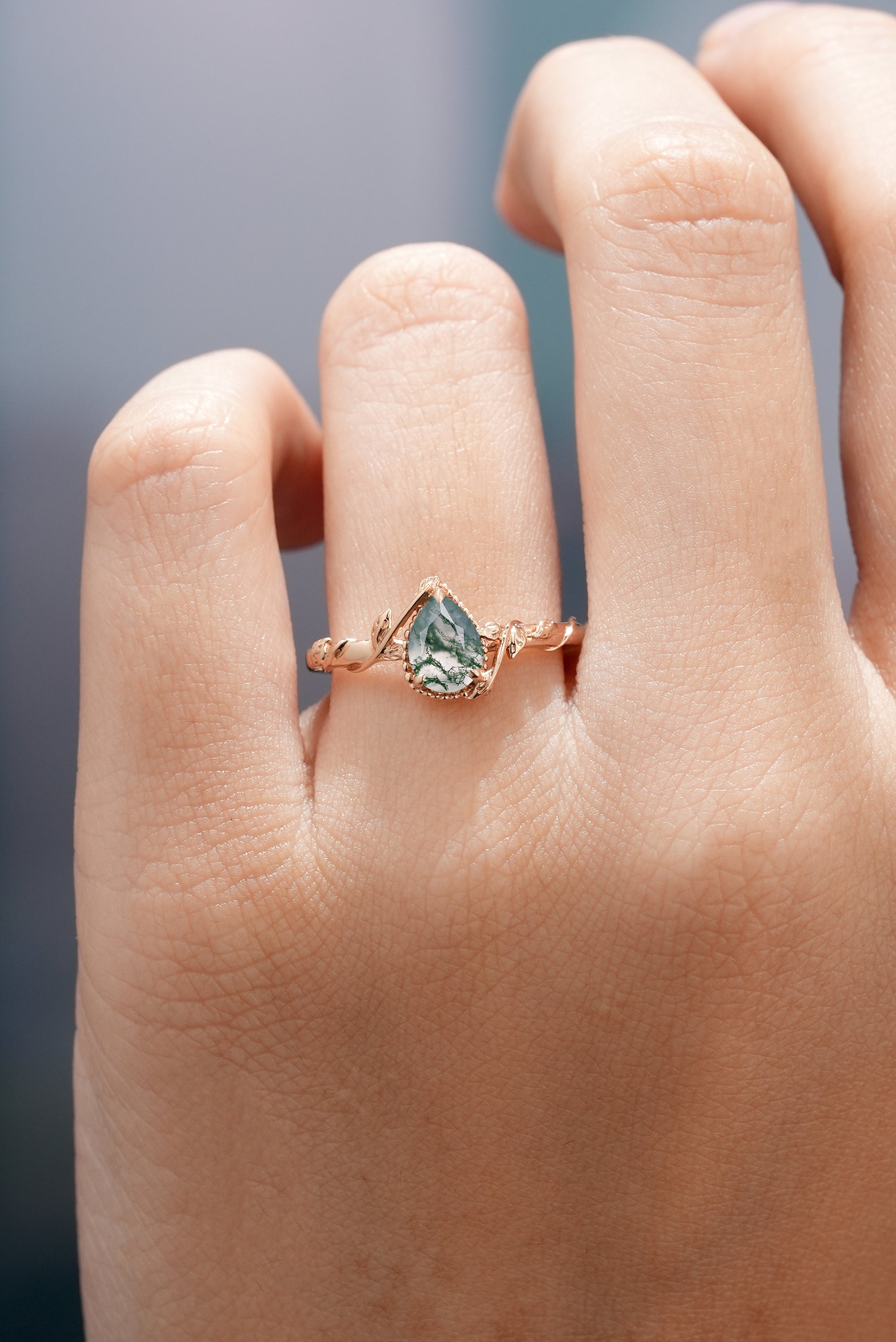 Moss agate engagement ring with leaf detailing, nature inspired design