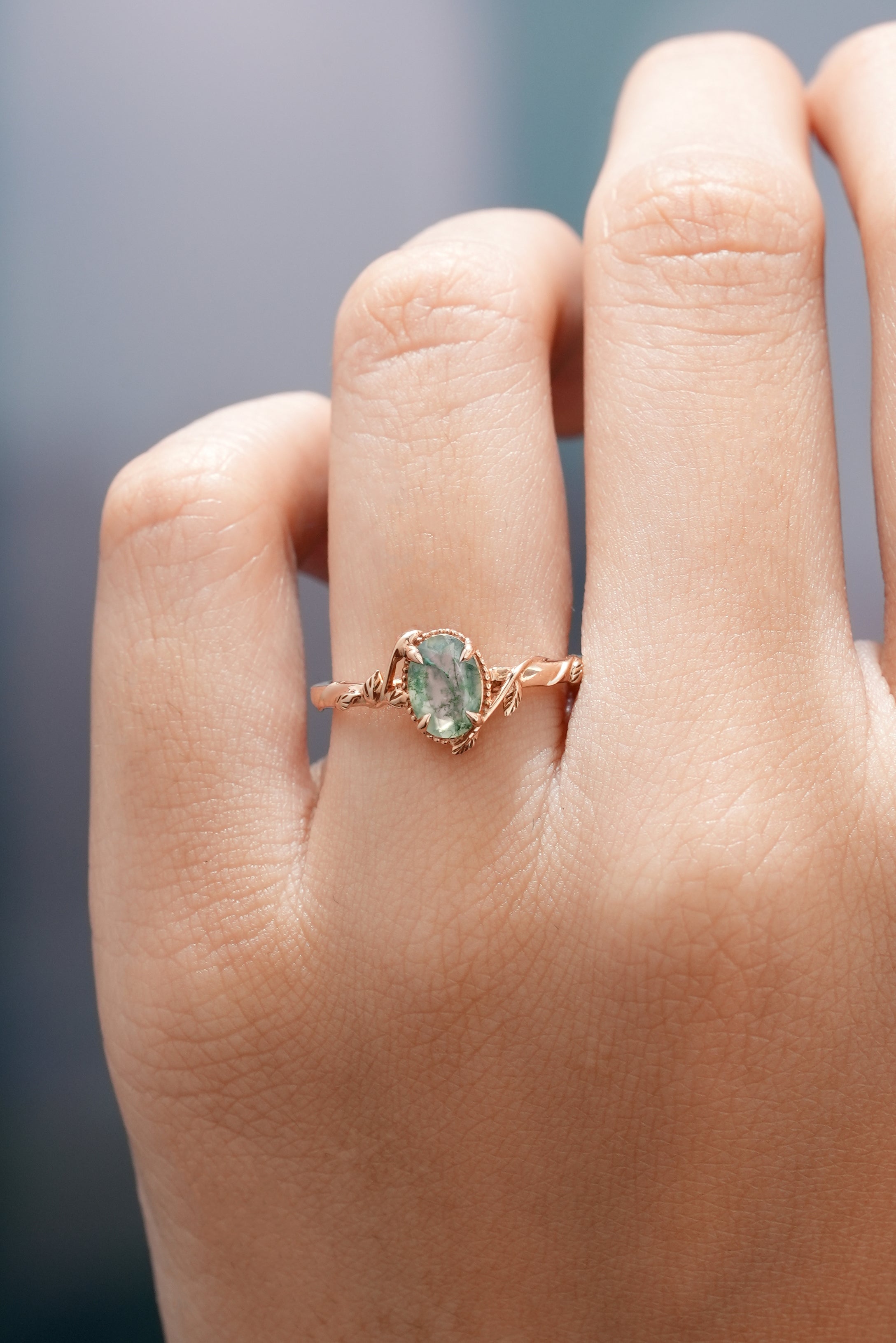 Oval Cut Nature Inspired  Leafy Moss Agate Engagement Ring In A Finger