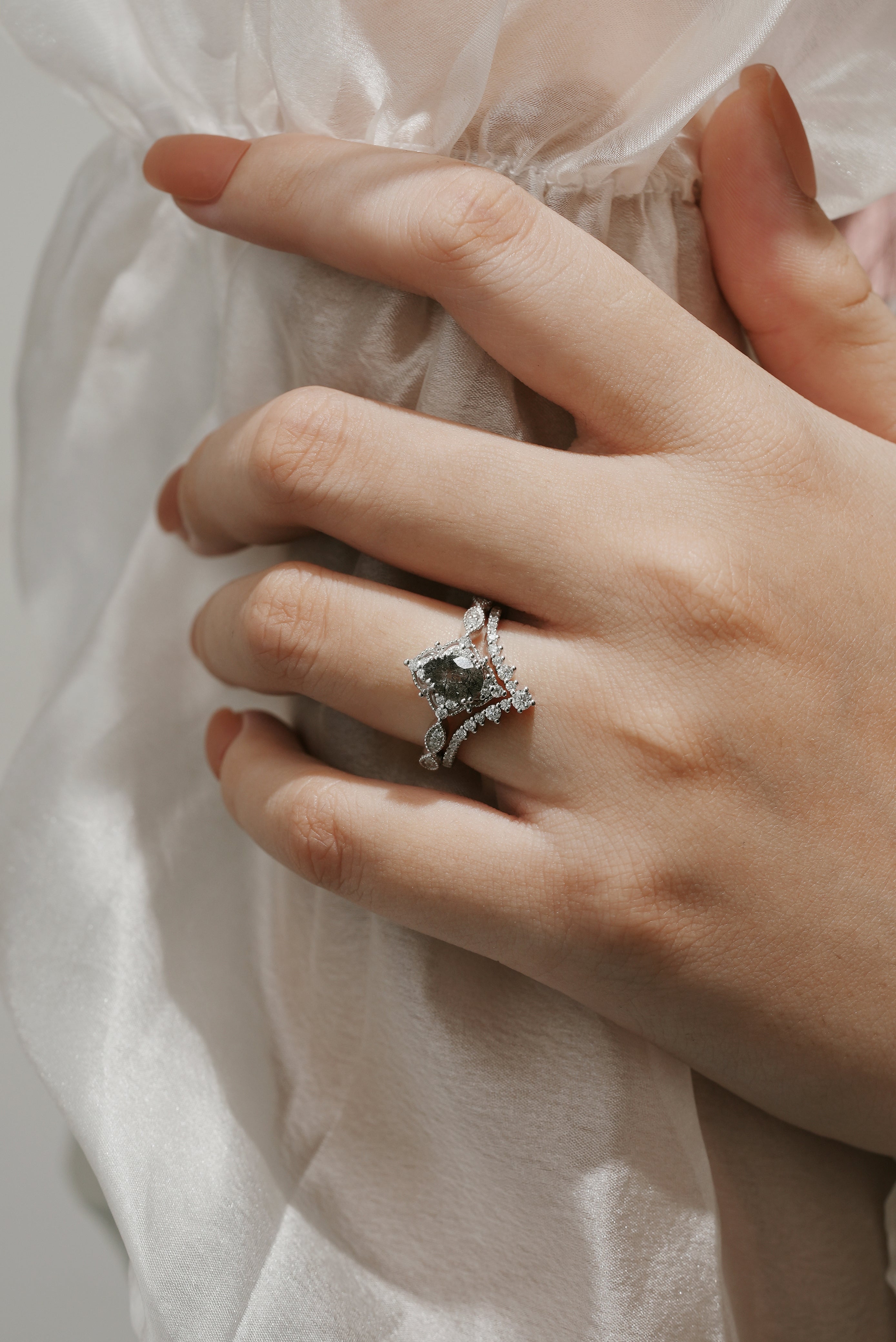 Woman's hand wearing black rutilated quartz engagement ring set