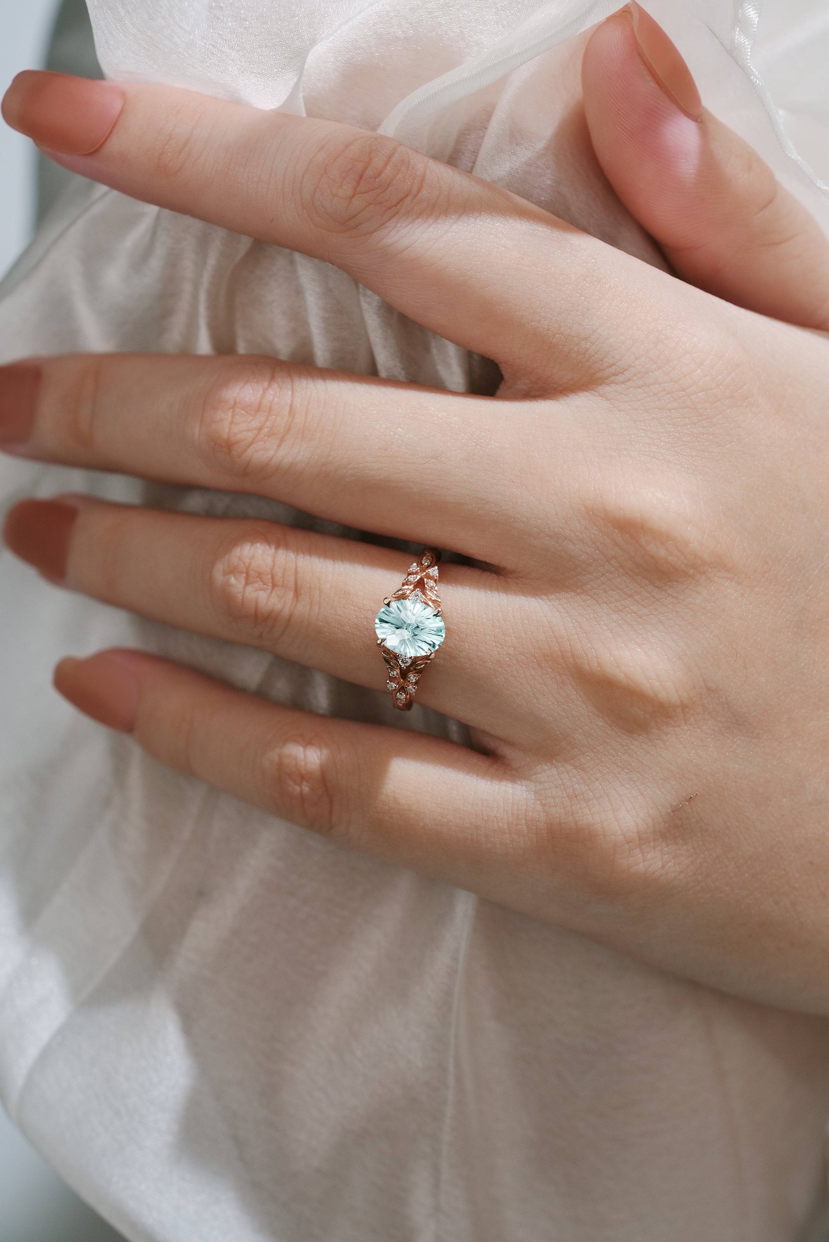 Oval Cut Aquamarine Leaf Engagement Ring In Finger