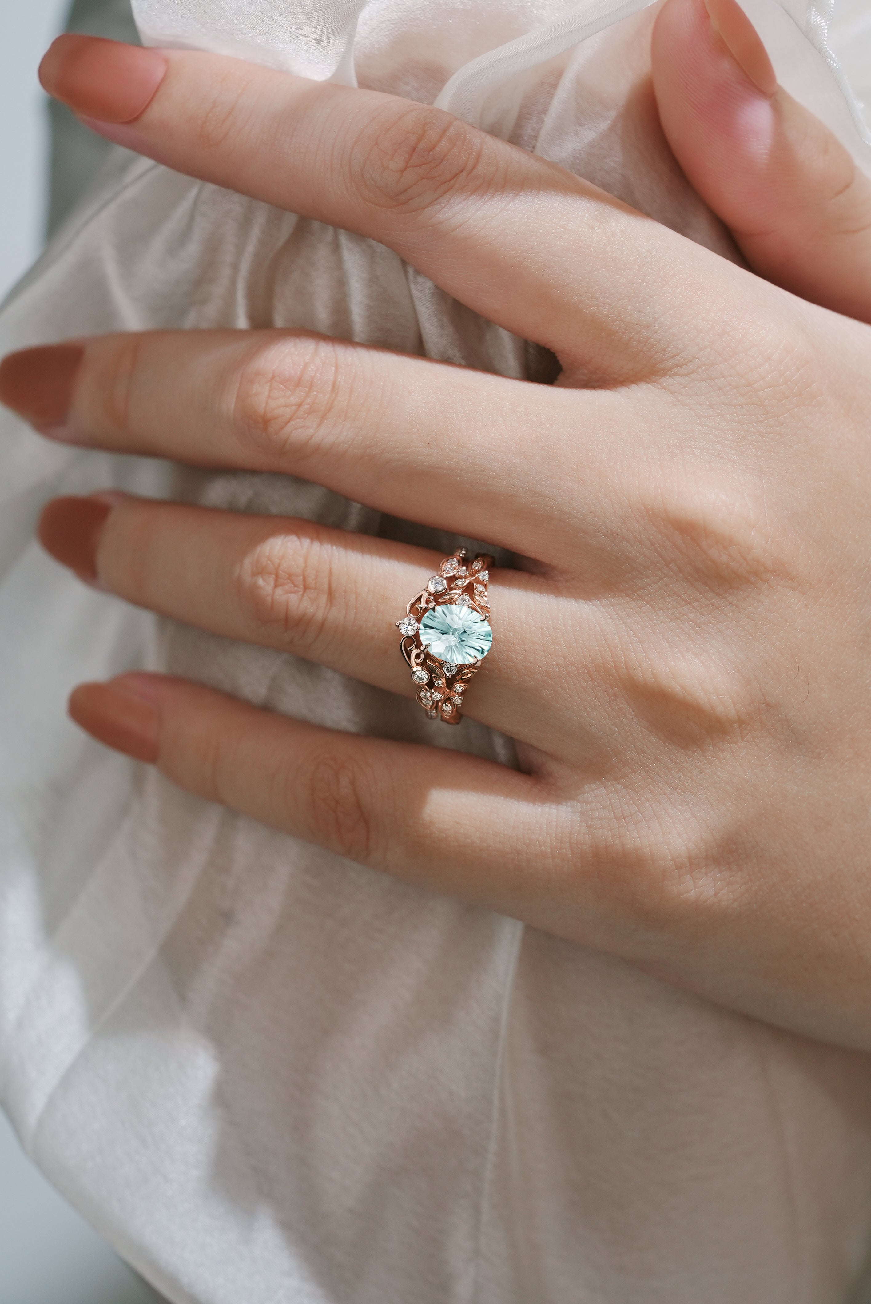 Aquamarine leaf engagement ring on a hand