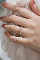 Rose gold engagement ring with opal center stone and moissanite accents, bridal ring set