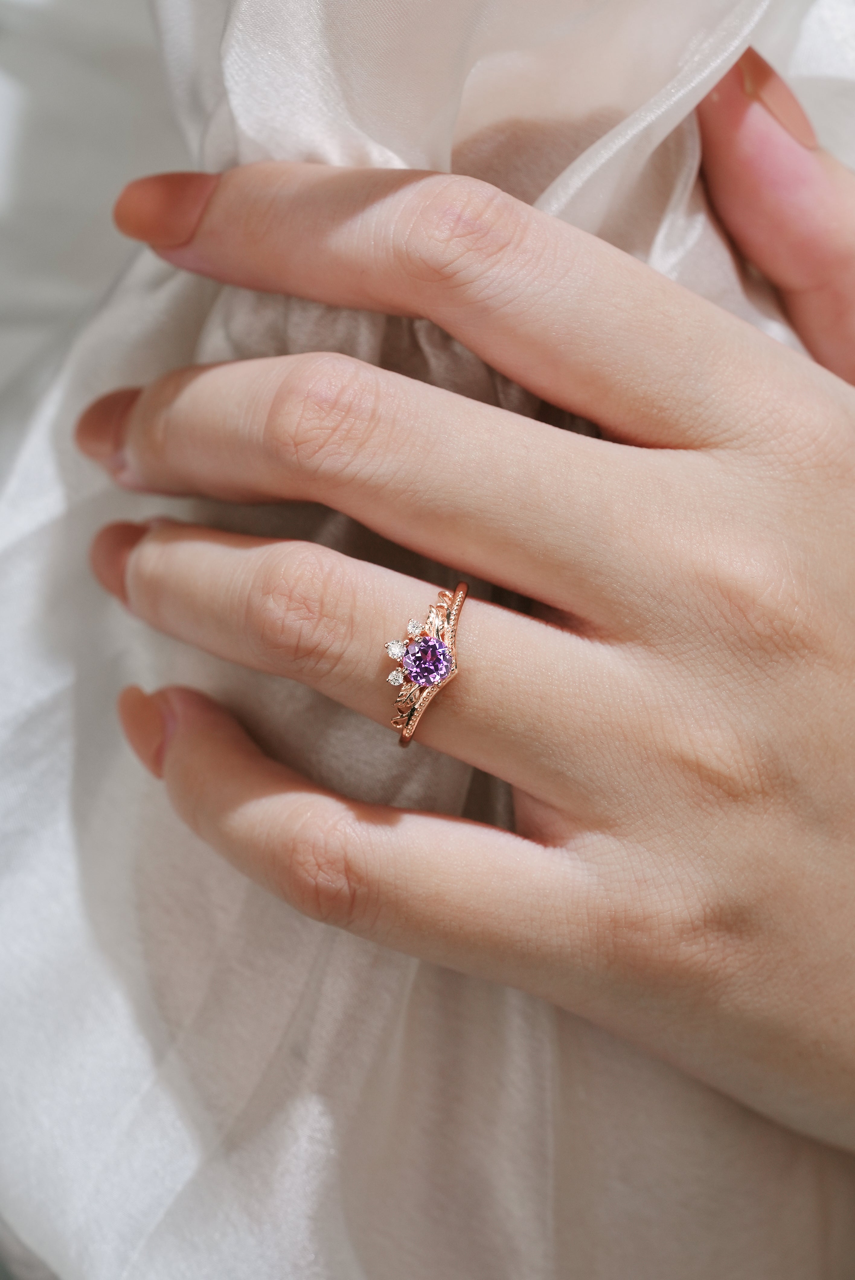 Woman wearing purple sapphire leaf engagement ring. Lahela Jewelry