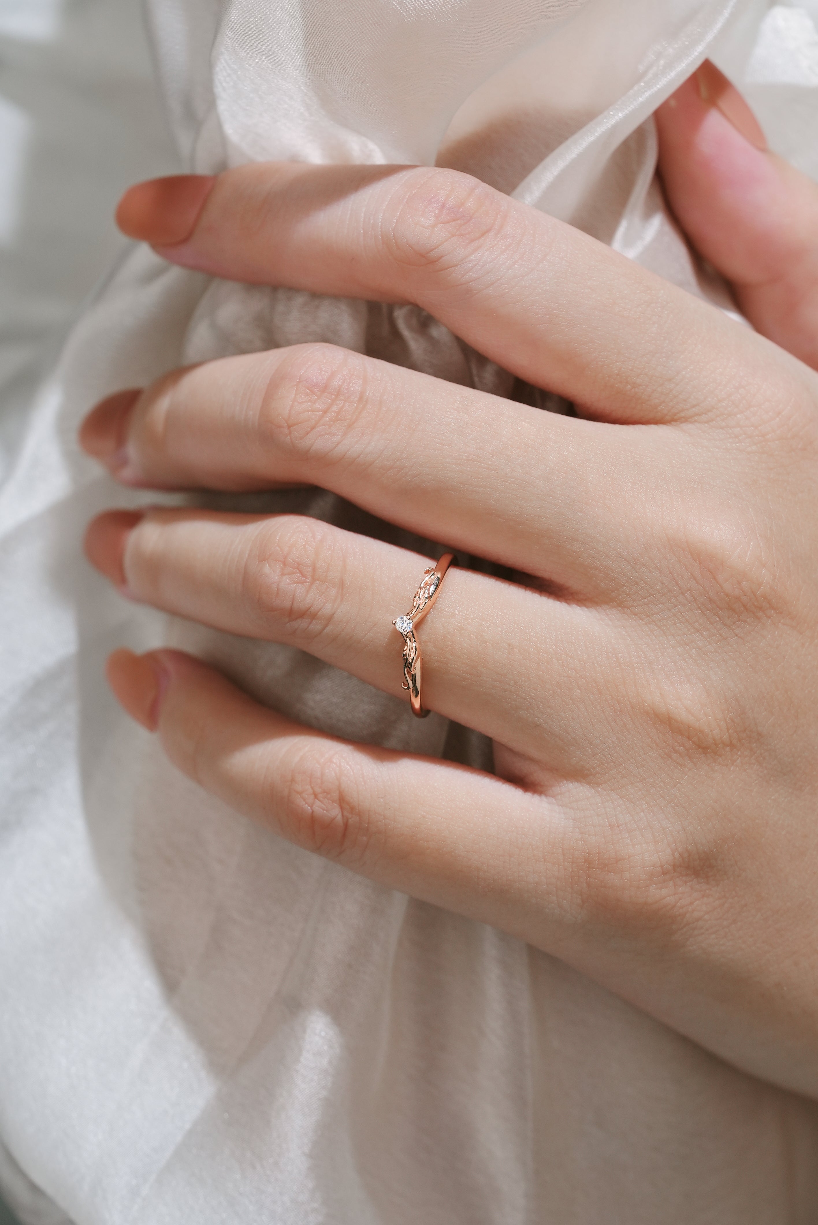 Hand wearing V-shaped moissanite wedding band