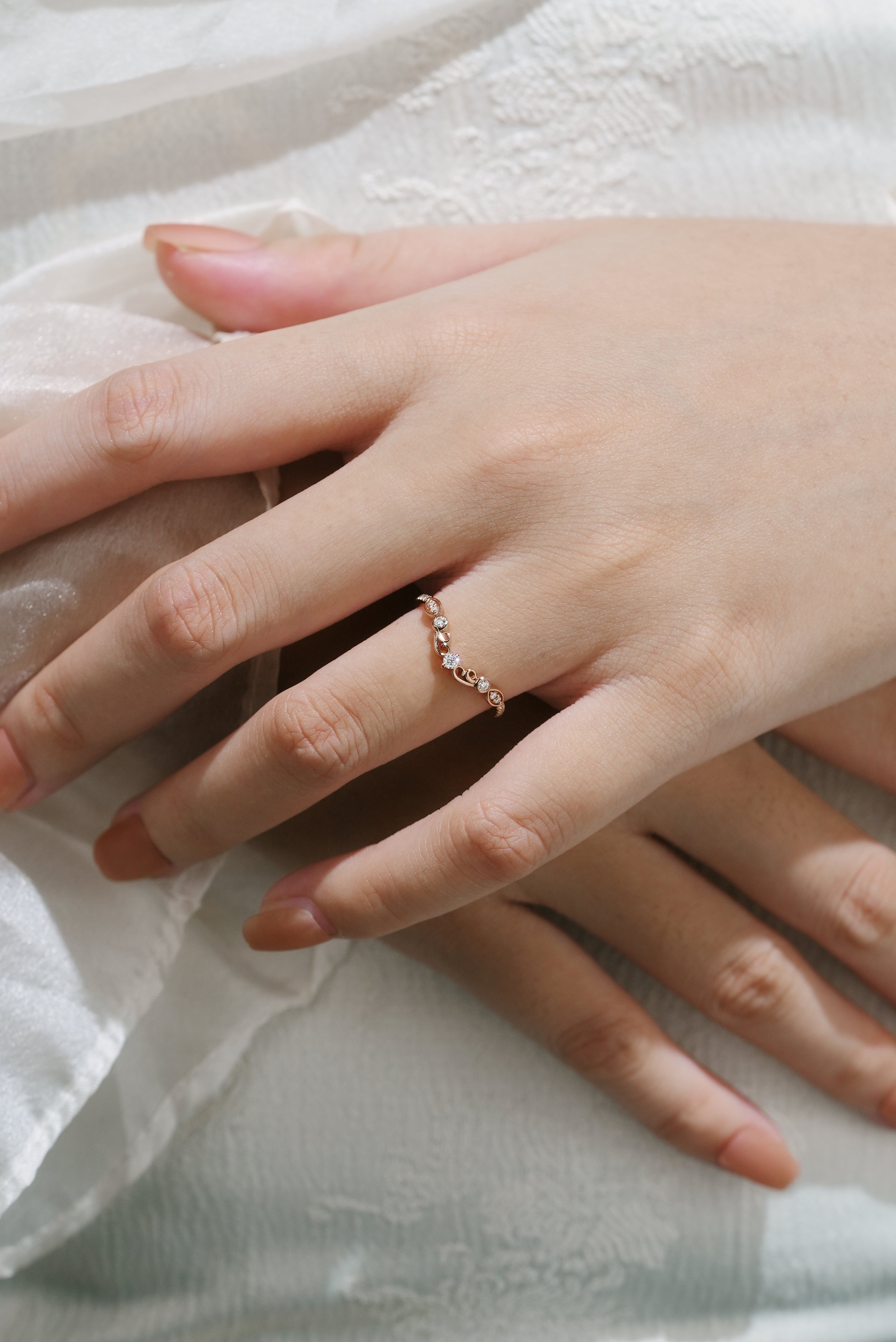 Rose gold moissanite chevron wedding band on a hand, vintage design, bridal ring.