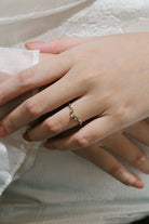 Hand wearing moss agate curved wedding band