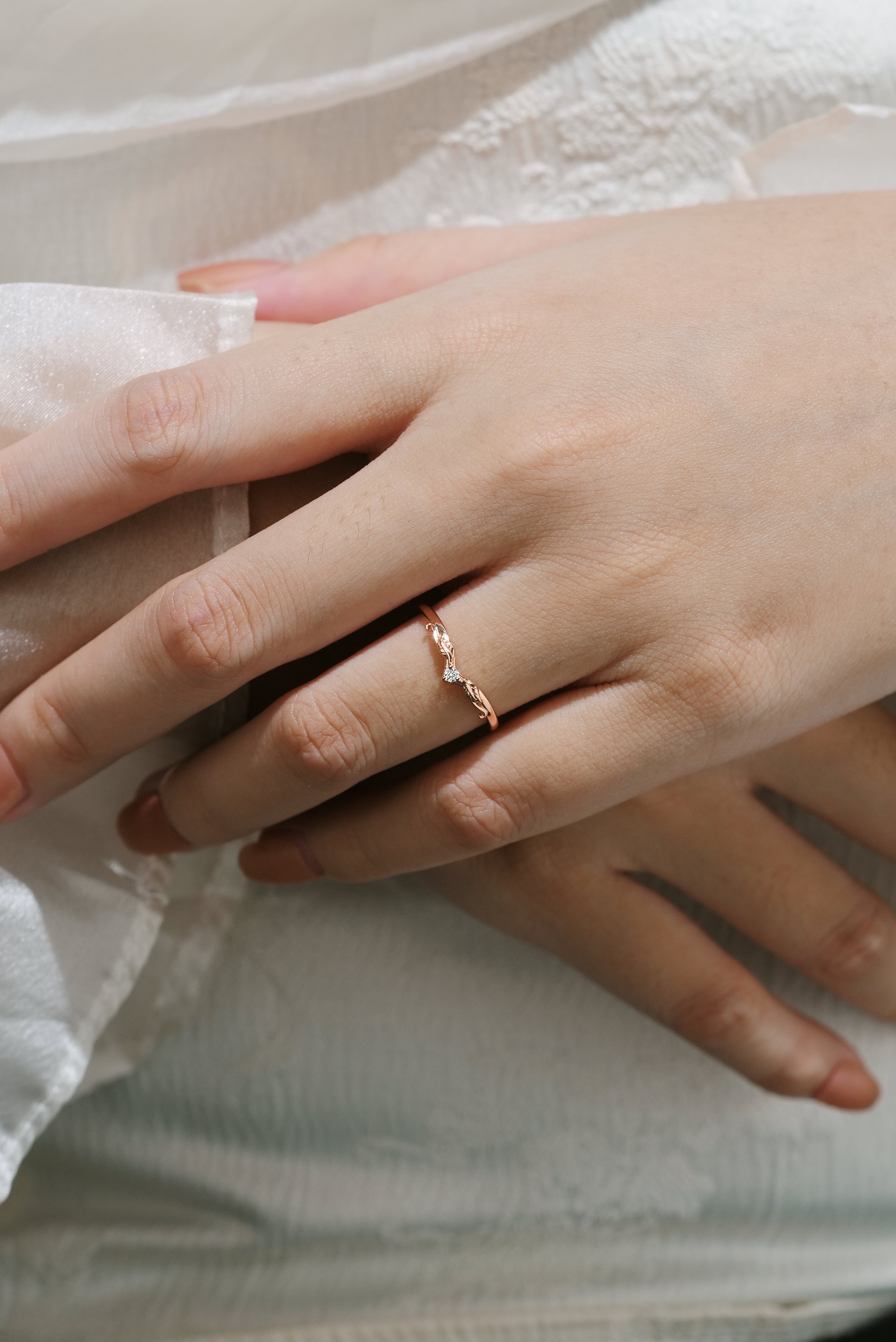 Rose gold moissanite leaf wedding band on hand