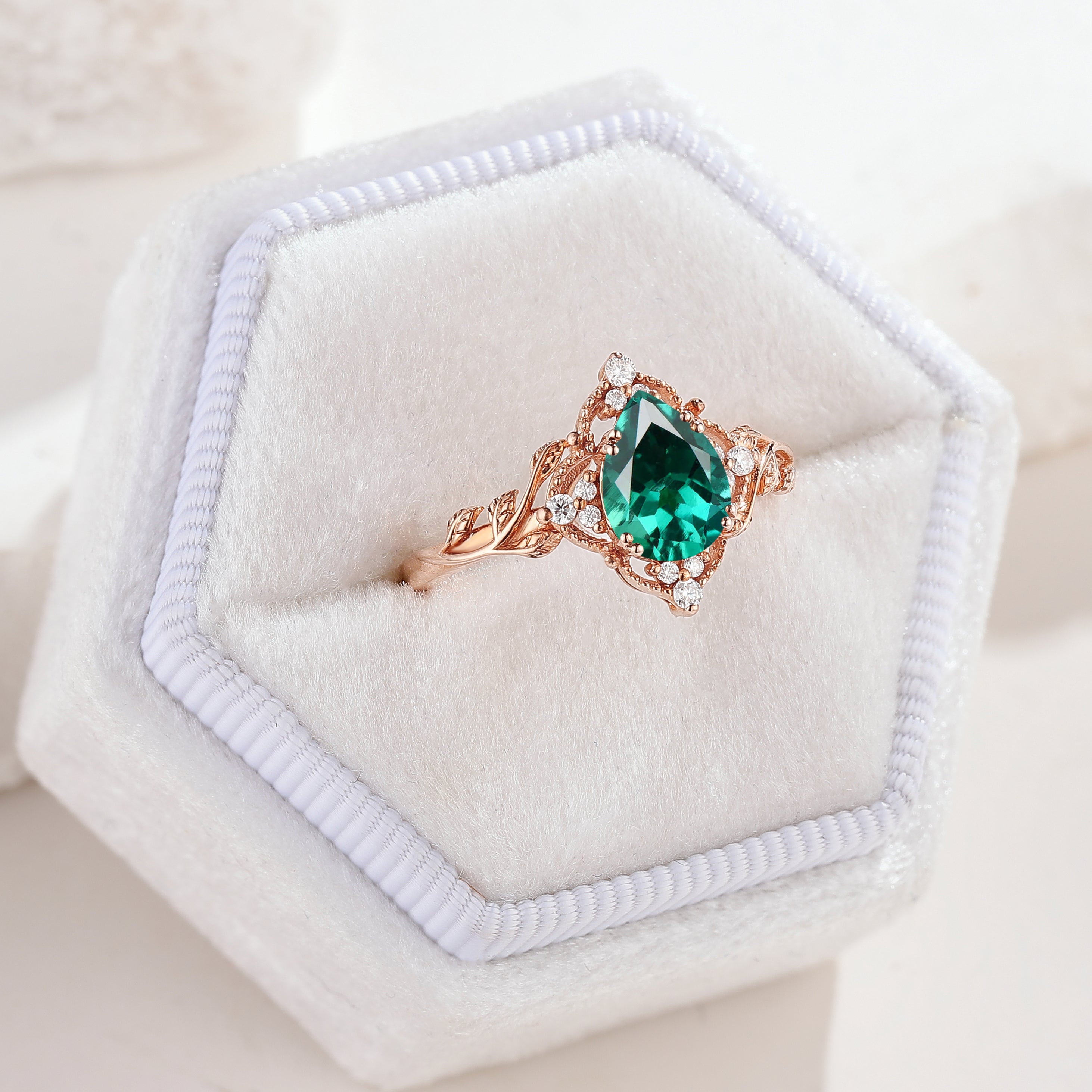 Nature Inspired Leaf Engagement Ring Pear Cut Lab Emerald Ring In A White Ring Box