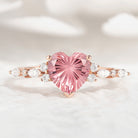 Heart-cut Padparadscha engagement ring with moissanite accents